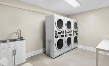 Guest Laundry Laundry room with washers and dryers for extended-stay guests at Latitude Suites