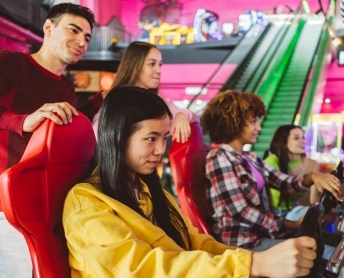Friends enjoying arcade games indoors at Jersey Shore
