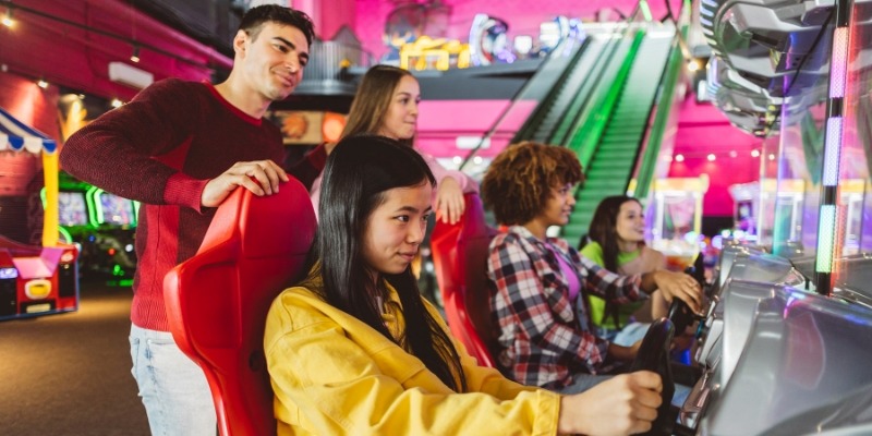 A group of friends enjoying an arcade game together, showcasing fun indoor activities at Jersey Shore.