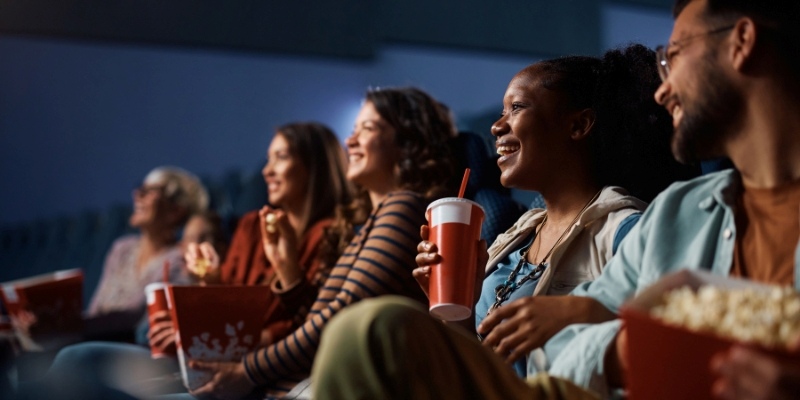 A group of people in a theater, engaged in watching a movie as part of indoor entertainment at New Jersey.