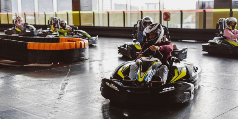 Kids racing go-karts on an indoor track at iPlay America, a popular attraction in Jersey Shore.