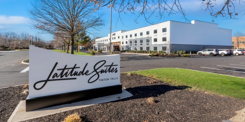 Exterior view of Latitude Suites, highlighting its contemporary design and proximity to attractions.