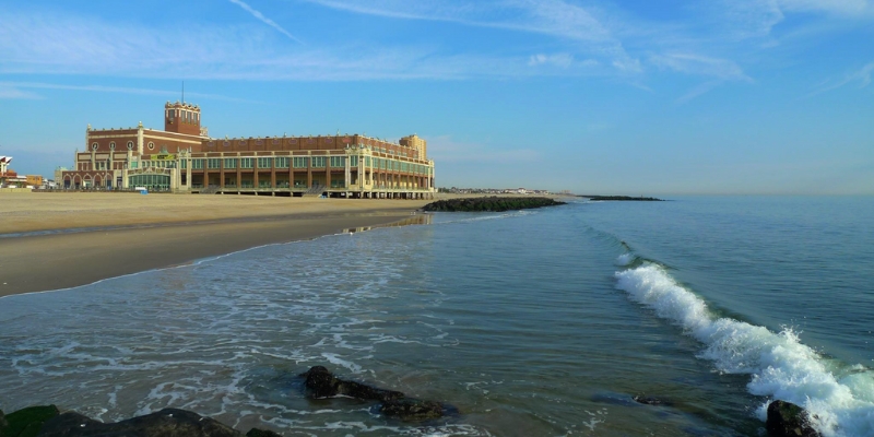 Asbury Park Beach showcasing a sandy shore with a building, representing a popular destination near Asbury Park.