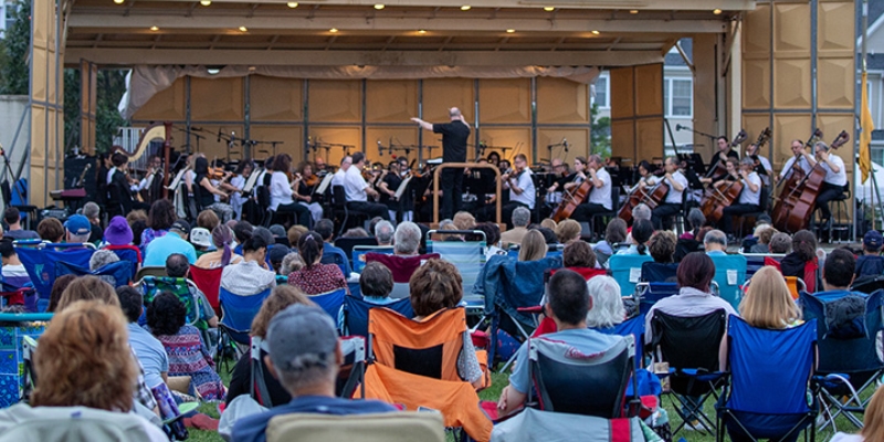 A large crowd enjoys an outdoor orchestra performance at the Count Basie Center during Jersey Shore activities.