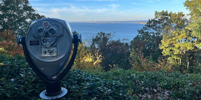 Binoculars for public use at Mount Mitchill Scenic Overlook, overlooking the water as the sun sets over the Jersey Shore.