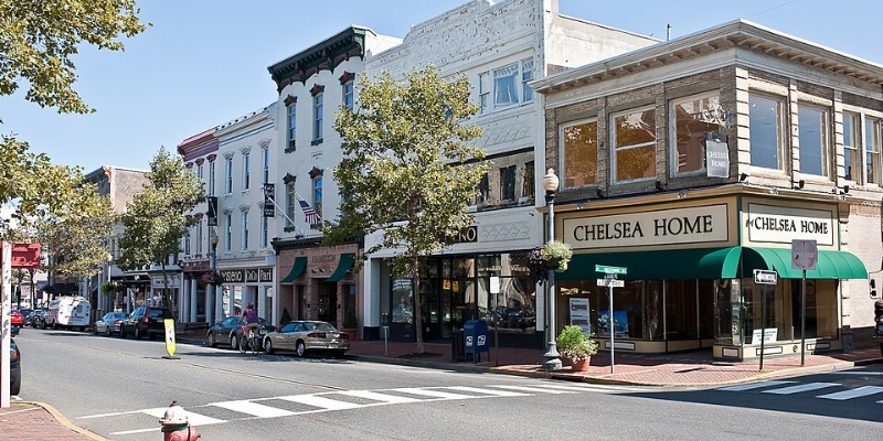 Downtown Red Bank, NJ, showcasing a lively street lined with buildings and a distinctive green awning.