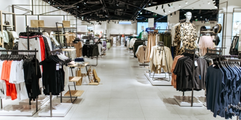 A vibrant clothing store in Monmouth Mall, Tinton Falls, displaying an assortment of fashion items for shoppers.
