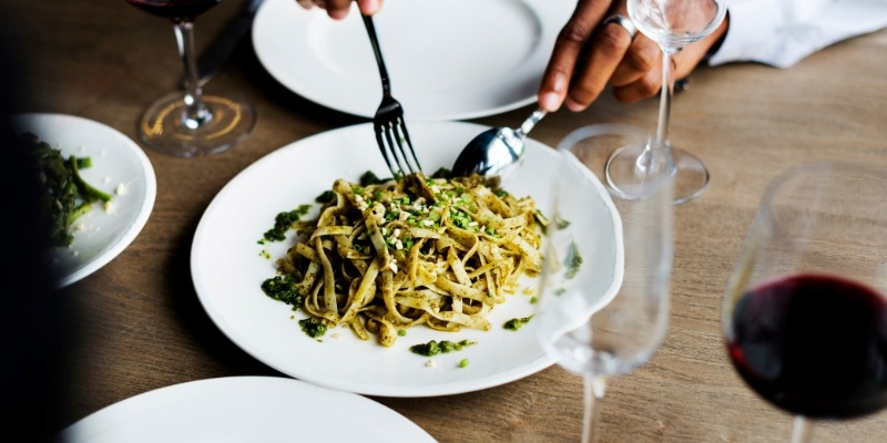 A white bowl filled with pasta, meat, and herbs, representing a dish from Nettie’s House of Spaghetti near Tinton Falls, NJ.