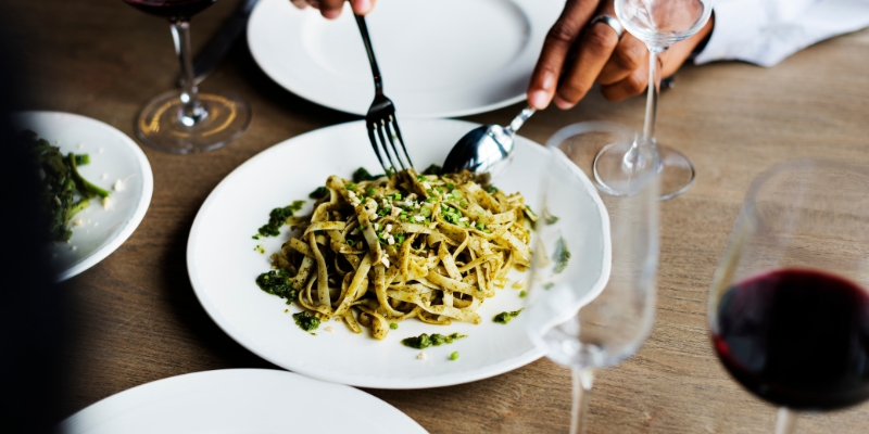 A white bowl filled with pasta, meat, and herbs, representing a dish from Nettie’s House of Spaghetti near Tinton Falls, NJ.
