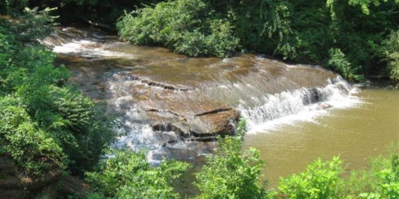 A tranquil waterfall nestled in a vibrant forest, representing a popular attraction in Tinton Falls, NJ.