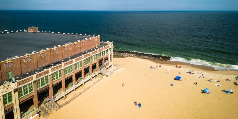 Aerial view of a beach alongside a building, illustrating the charm of the best beaches near Asbury Park.