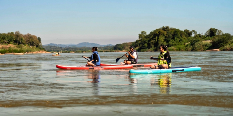 A group of people paddle a kayak down the Shrewsbury River, enjoying outdoor activities at Jersey Shore.