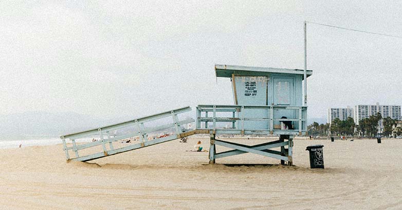 A lifeguard house standing on the sandy beach, ready to watch over swimmers.