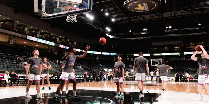 A group of men playing basketball on a court near Monmouth University, showcasing an active sports scene.