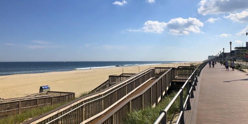 The boardwalk guides visitors from the beach to the ocean at Long Branch, embodying the vibrant atmosphere of Jersey Shore summer.