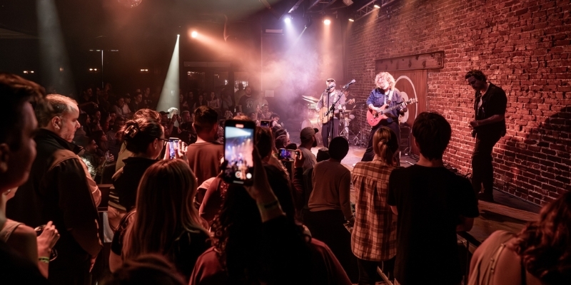 A lively crowd enjoying a band performance on stage at the Jersey Shore, highlighting local culture and entertainment.