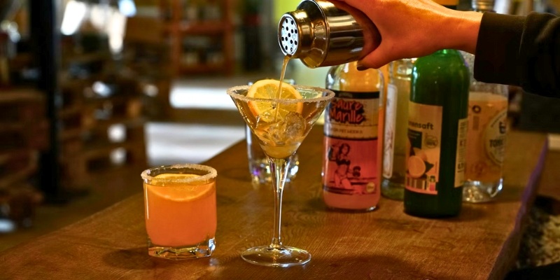 A bartender is crafting a cocktail at a bar, representing the cocktail scene in Asbury Park, New Jersey, this August.