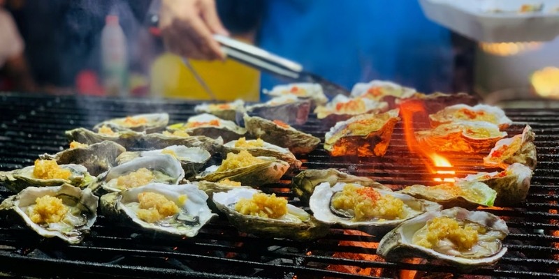Grilled oysters served at the Red Bank Guinness Oyster Festival in New Jersey, showcasing a summer culinary delight.