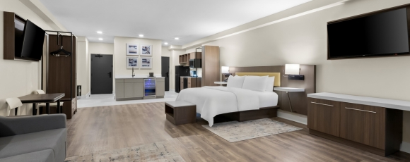 A hotel room featuring a bed, desk, and television, promoting exclusive offers near the Count Basie Center for the Arts.