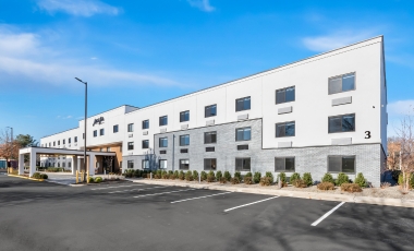 Exterior view of Latitude Suites, located near Count Basie Center for the Arts with free parking.