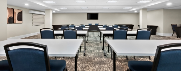 Conference room featuring tables and chairs, suitable for special events near the Count Basie Center for the Arts.