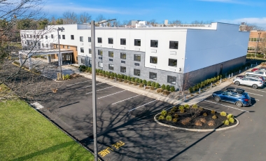 Hotel Near Wall Stadium Speedway - Complimentary Parking Exterior view of the Latitude Suites showcasing contemporary design and proximity to Wall Stadium Speedway.