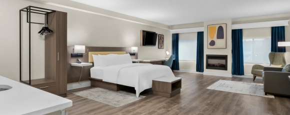 Hotel Near Wall Stadium Speedway - Extended Stay Comfortable hotel room with a bed, desk, and television, part of the Extended Stay near Wall Stadium Speedway.