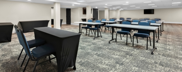 Conference room at Hotel Tinton Falls, NJ, featuring tables and chairs arranged for an event.