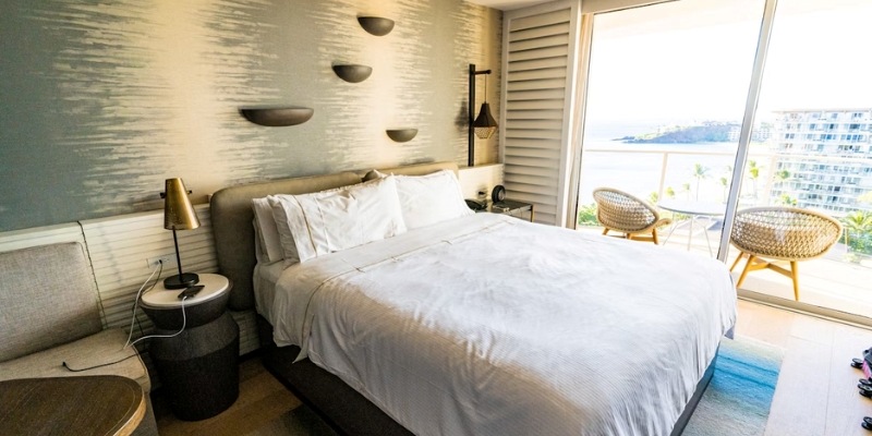 A hotel room featuring a bed and a stunning ocean view, showcasing the Asbury Ocean Club Hotel at Jersey Shore.