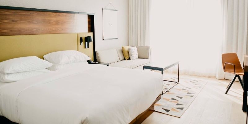 Hotel room at Bungalow Hotel featuring a bed, desk, and chair, designed for comfort and relaxation at Jersey Shore.