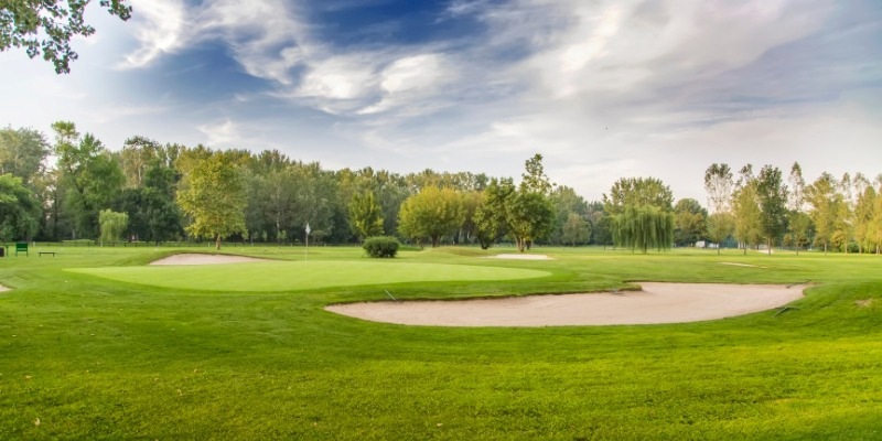 A scenic golf course featuring lush green grass and trees, part of the Stockton Seaview Hotel & Golf Club at Jersey Shore.