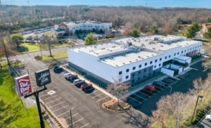 Hotel near Gateway National Recreation Area - Free Parking Exterior view of a hotel in a parking lot, located near Gateway National Recreation Area with free parking available.