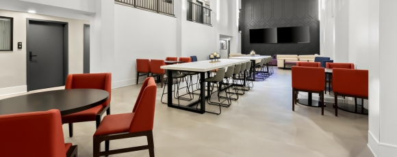 Hotel near Monmouth Mall - Dining Onsite Contemporary hotel bistro and bar showcasing red chairs and tables, conveniently located near Monmouth Mall with dining available.