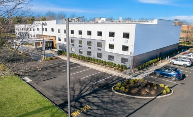 Exterior view of the Latitude Suites, showcasing the Free Parking.