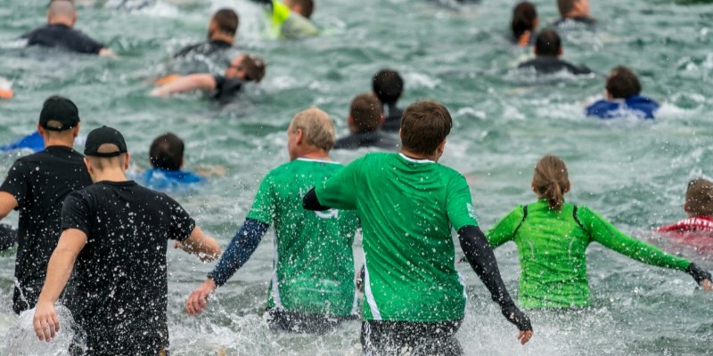 A group of people enjoying the winter waves at Jersey Shore during the Special Olympics New Jersey event.