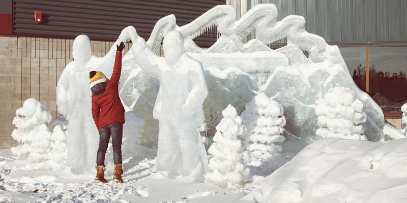 A person is next to a stunning ice sculpture at the Jersey Shore, capturing the essence of winter in January.
