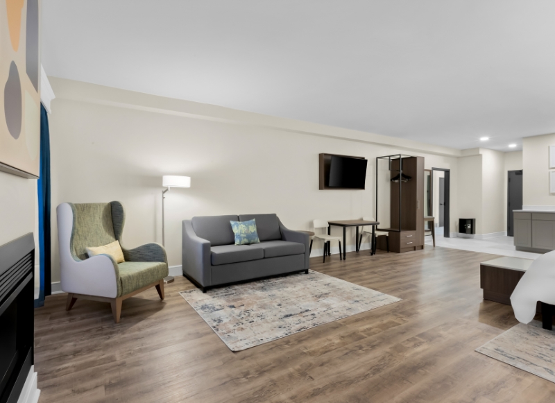 Hotel Near Hackensack University Medical Center NJ - 1 Hotel room featuring a bed, couch, and television, located near Hackensack University Medical Center, NJ.