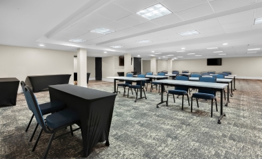Conference room featuring tables and chairs, designed for events at Hotel Near Twin Lights Historic Site.