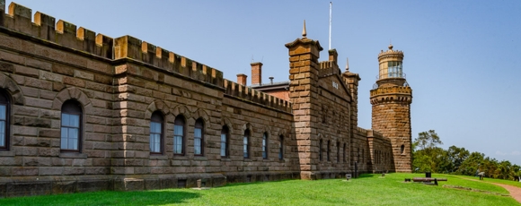 Twin Lights Historic Site showcases an old stone structure with a large tower, highlighting its architectural significance.