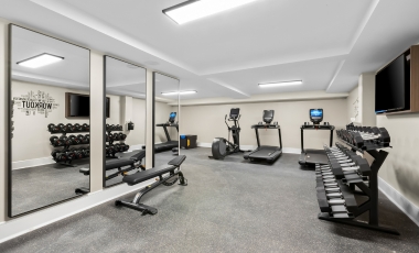 A hotel with well-equipped gym with mirrors and workout gear, situated at Stay Near Victory Stables