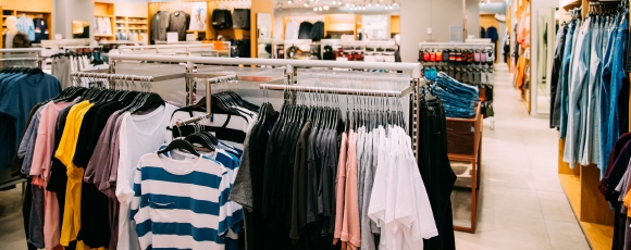 A clothing store featuring a variety of apparel, located near Victory Stables and other shopping options.