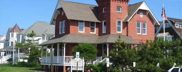 Sea Girt Lighthouse, a red brick house with a prominent tower on top.