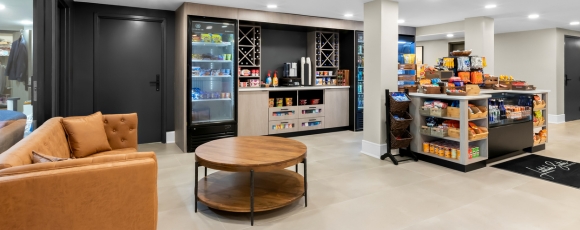 Elegant hotel lobby with a grocery and comfortable seating, situated near Twin Lights State Historic Site, offering grocery delivery.
