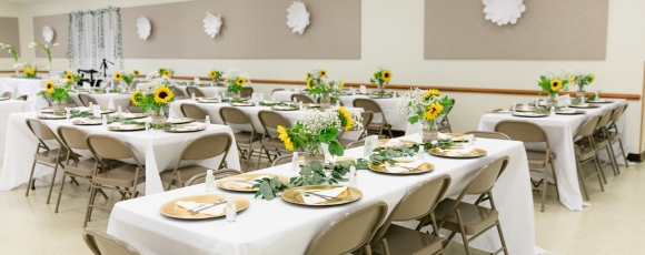 A banquet room elegantly arranged with tables and chairs for a wedding at the Hotel Near Shadowbrook at Shrewsbury.