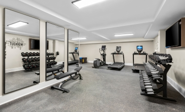 Fitness room featuring mirrors and gym equipment at a hotel near Two River Theater in Red Bank.