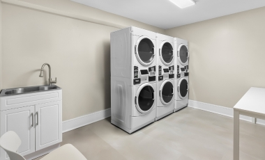 Guest laundry area with a washer and dryer, located in the hotel near Two River Theater, Red Bank.