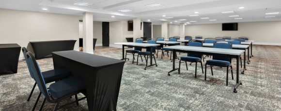 Conference room featuring tables and chairs, suitable for special events at the hotel near Two River Theater, Red Bank.