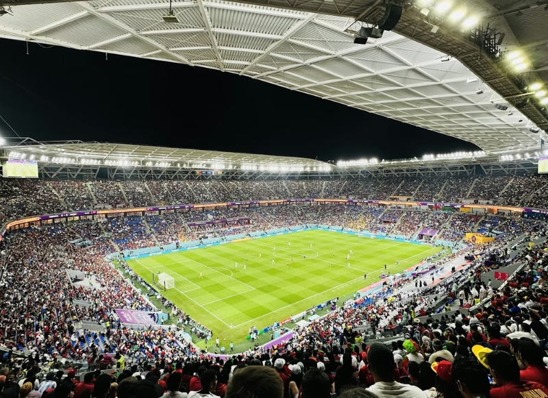 A vibrant soccer stadium filled with cheering spectators, capturing the thrilling atmosphere of a FIFA World Cup match in New Jersey.