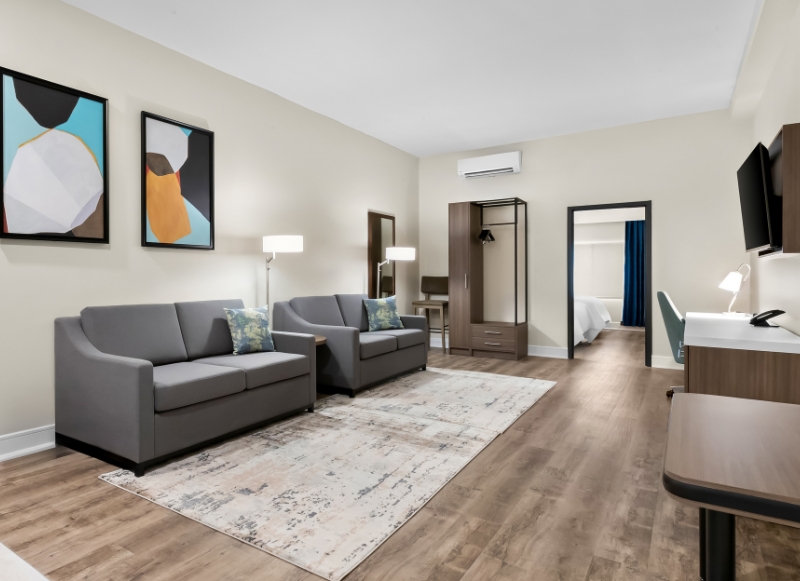 Modern hotel room showcasing a couch, desk, and television, conveniently located near the FIFA World Cup in New Jersey.