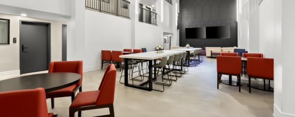 Hotel lobby with red chairs, TV near FIFA World Cup NJ.